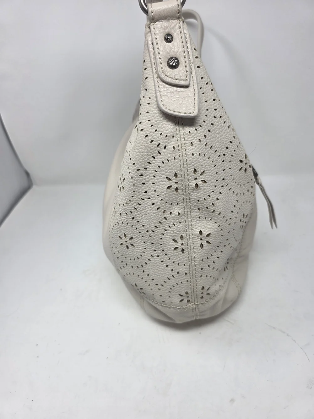 ​The Sak Off White Pebbled Leather Hobo Bag Perforated Cutout Tassel